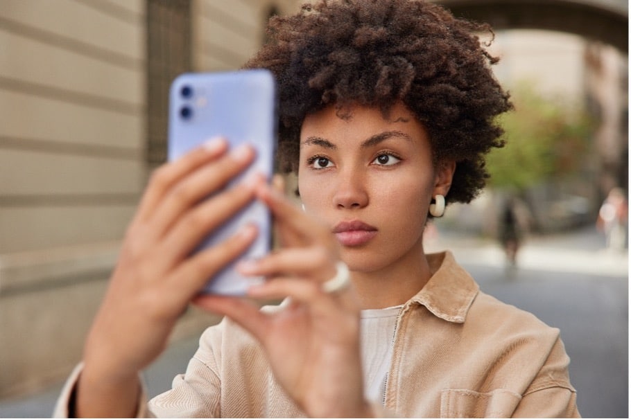 A female taking a picture with her phone