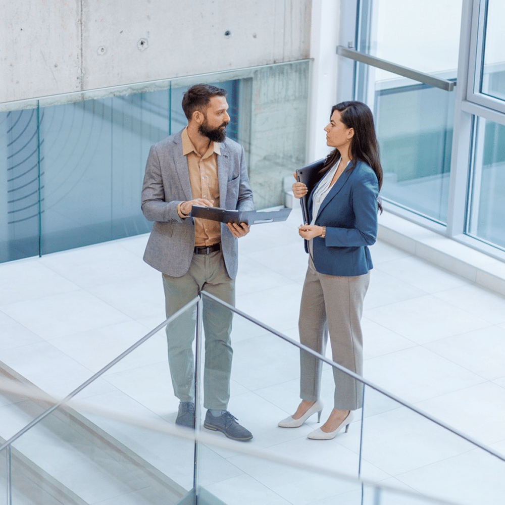 Two people discussing work with a tablet.