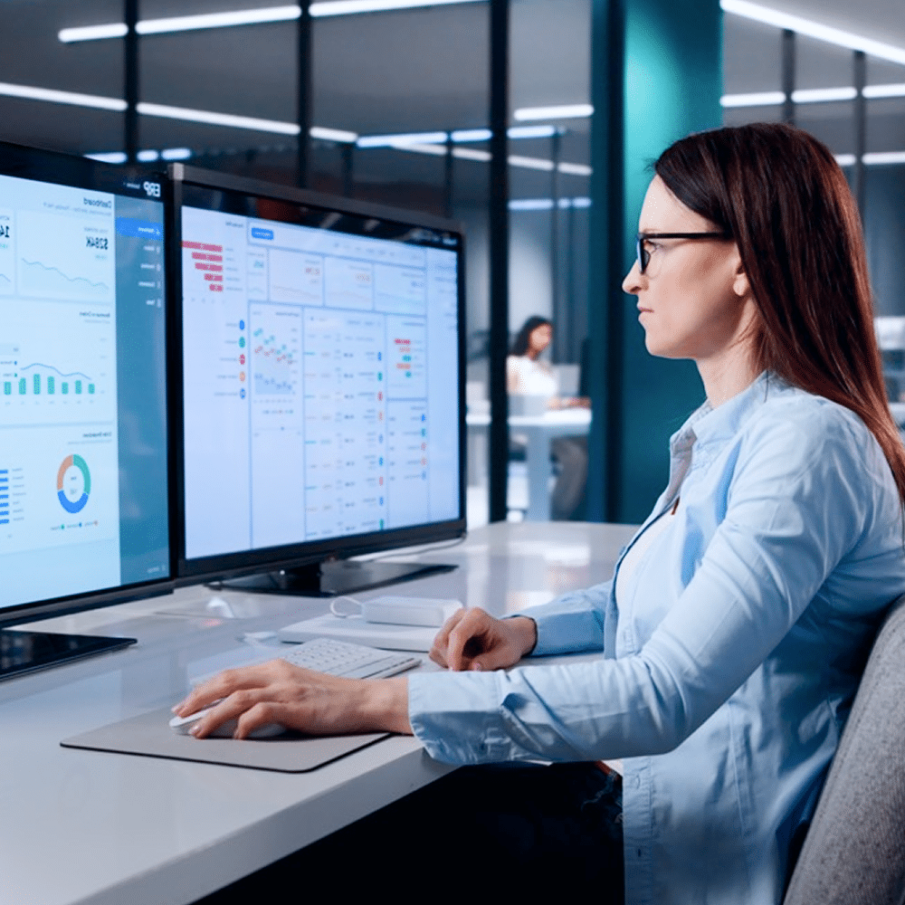 Person reviewing analytics on dual monitors.