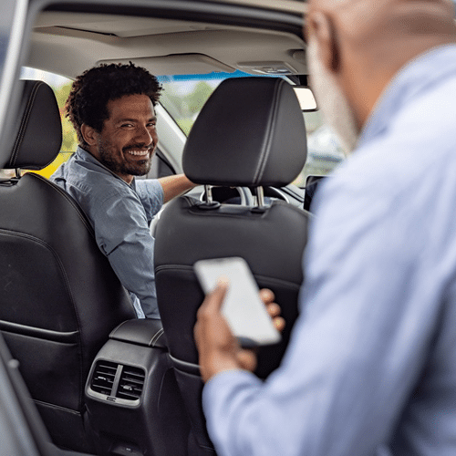 Passenger and ride share driver interacting inside a car