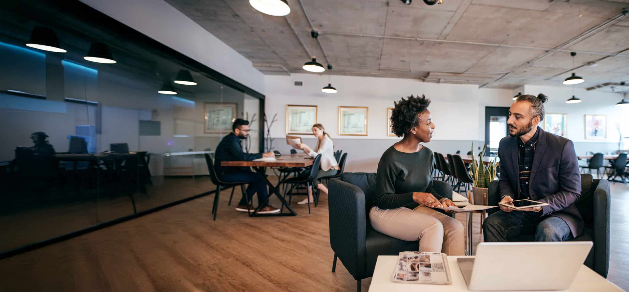 Co-workers chatting in the office lounge.